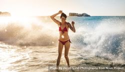 Happy woman in bikini enjoying beach waves bGZOx4