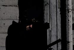 Modern man inside desolate building