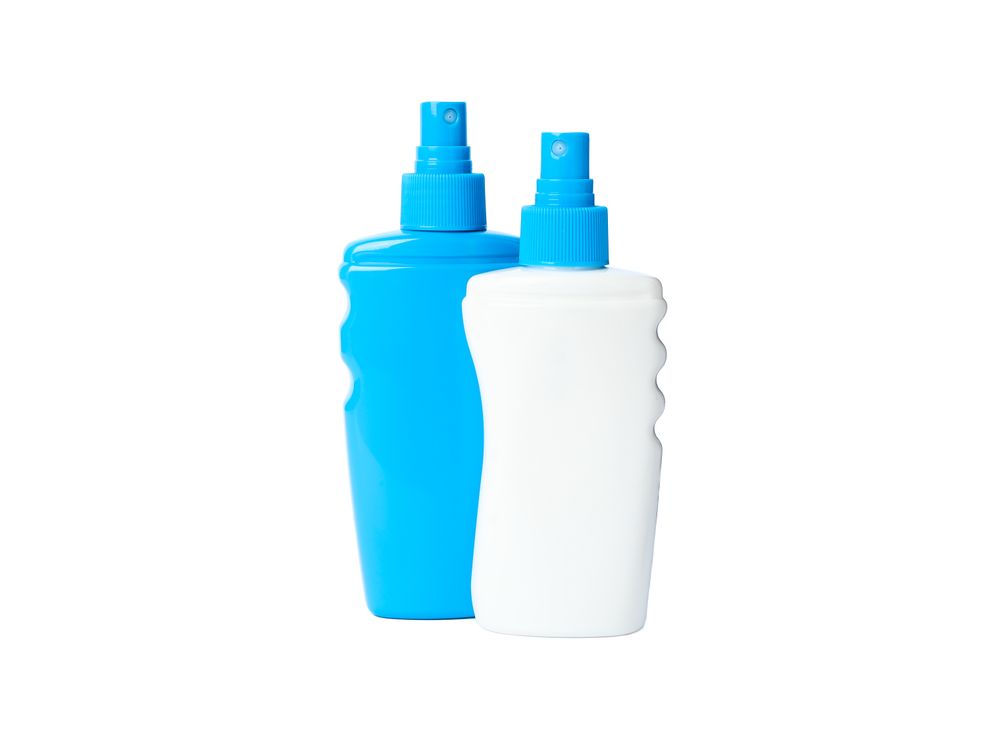 Sunscreen sprays isolated on studio background. Summer vacation accessories