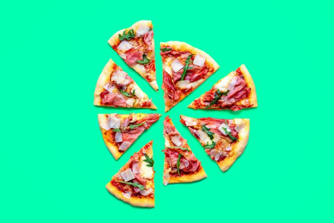 Ham pizza top view minimalist on a green table