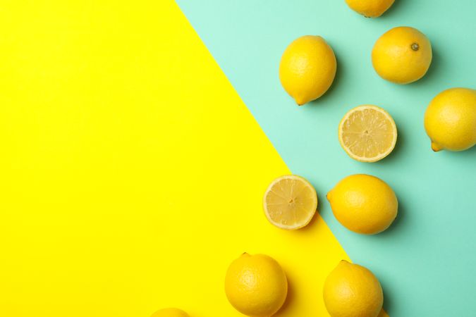 Fresh lemons on two tone background, top view. Ripe fruit