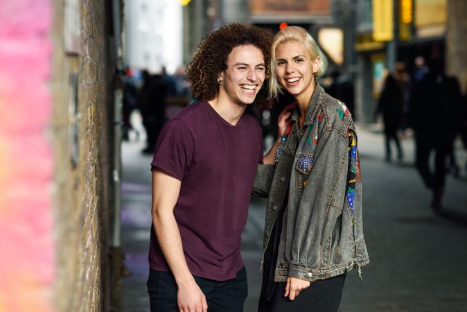 Male and female smiling on British city street