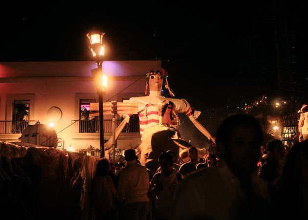 Large female effigy over street revelers in Oaxaca