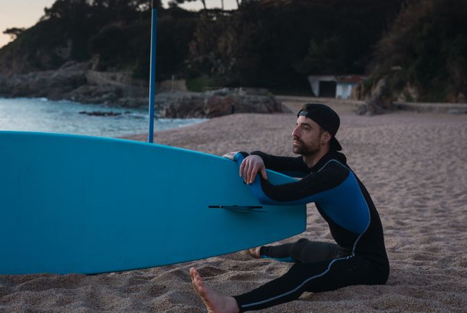 Man practicing paddle surfing with neoprene in a sunrise