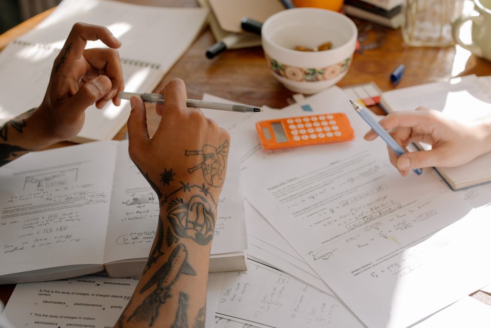 Cropped image of two people discussing math equation