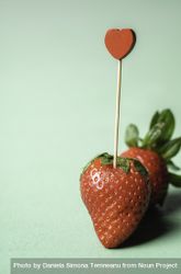 Ripe strawberry with a heart-shaped toothpick 5kGJo5