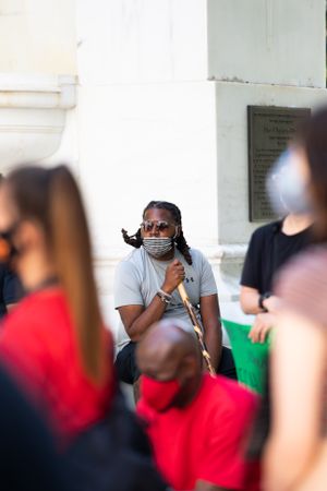 Los Angeles, CA, USA — June 16th, 2020: man with mask and cane listens to speakers at rally