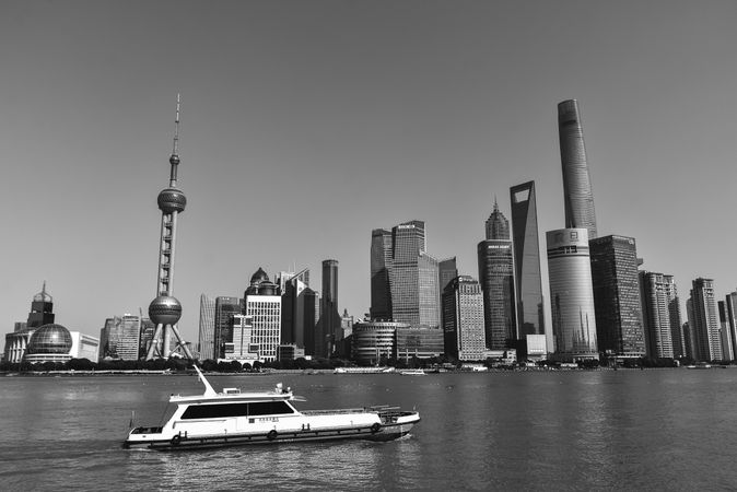 Grayscale photo of boat on water near city in Lujiazui, Pudong, Shanghai, China