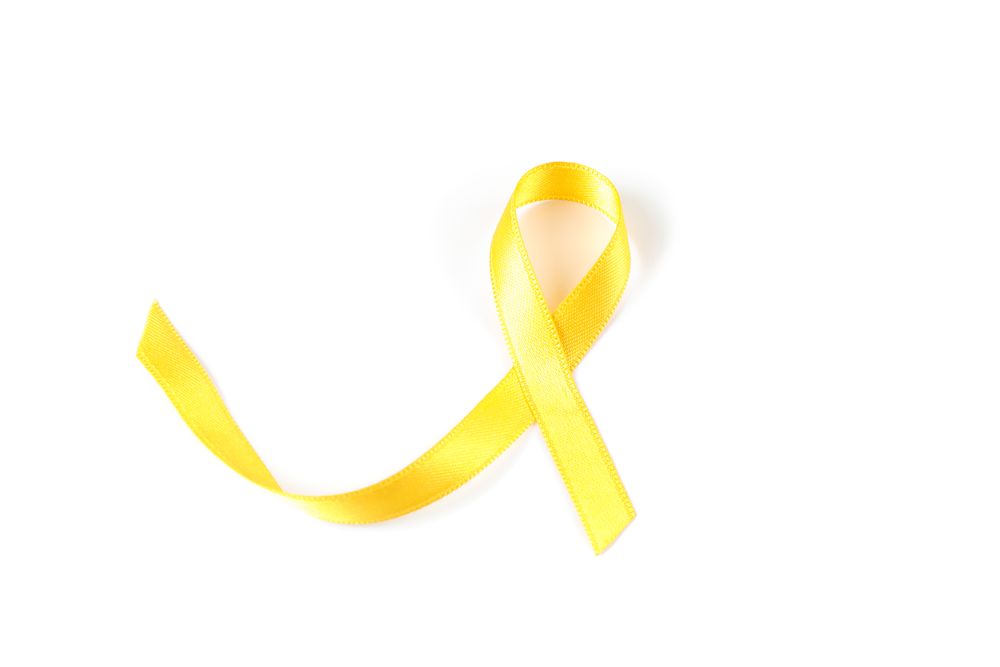Yellow awareness ribbon isolated on blank background