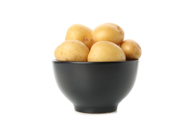 Bowl full of potatoes, side view