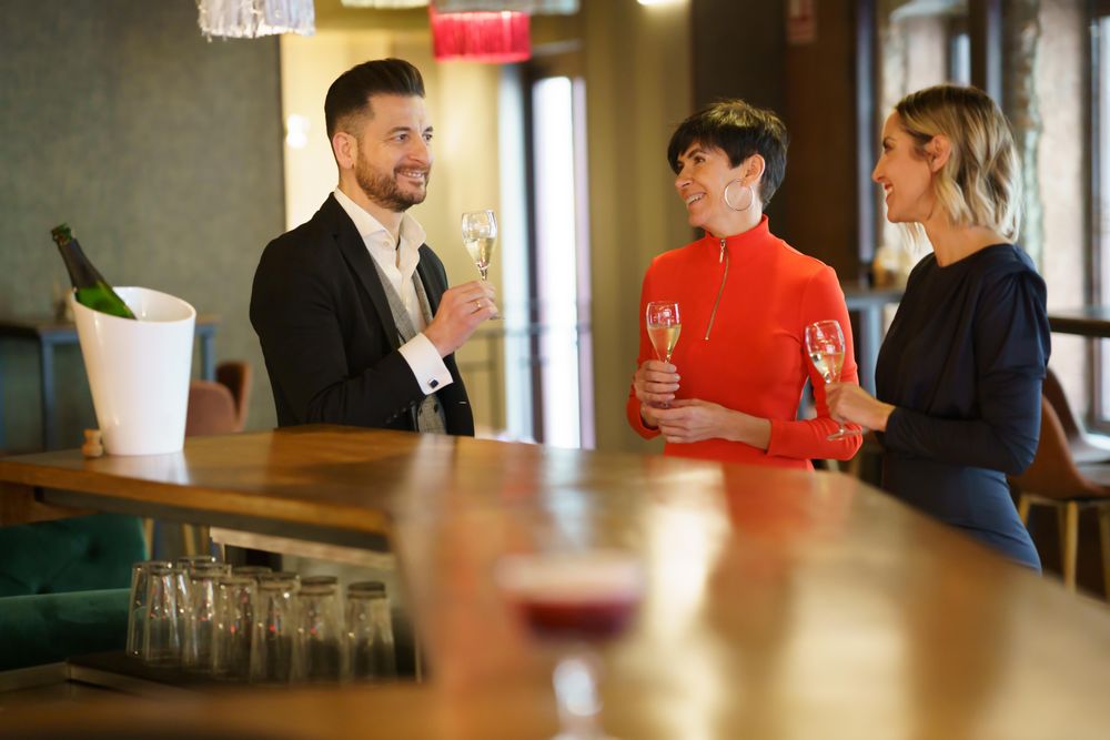 Group of people drinking sparkling wine at bar