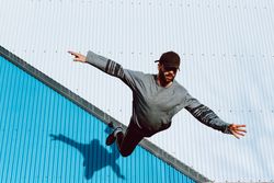 Trendy male flipping on street