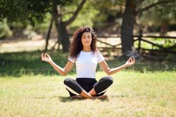 Arab woman doing meditation in nature