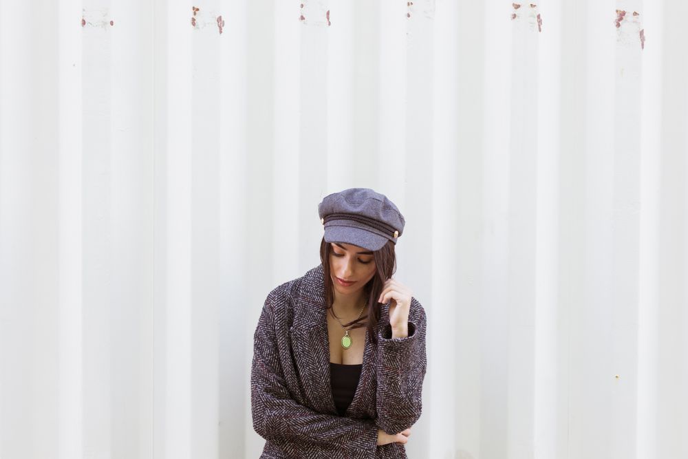 Charming Hispanic woman near wall