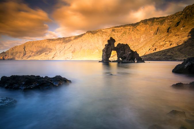 Amazing stone shore and pink sky with clouds
