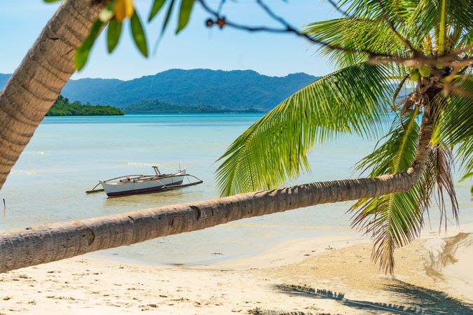 Boat on shallow of sandy sea shore