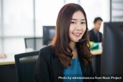 Portrait of smiling woman at work wearing headset bxDJXb
