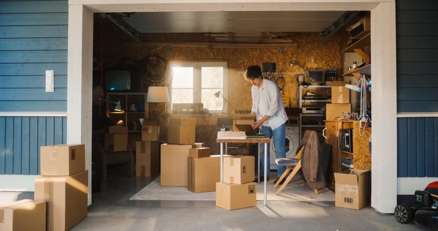 Businessman Using Laptop Computer In Garage.