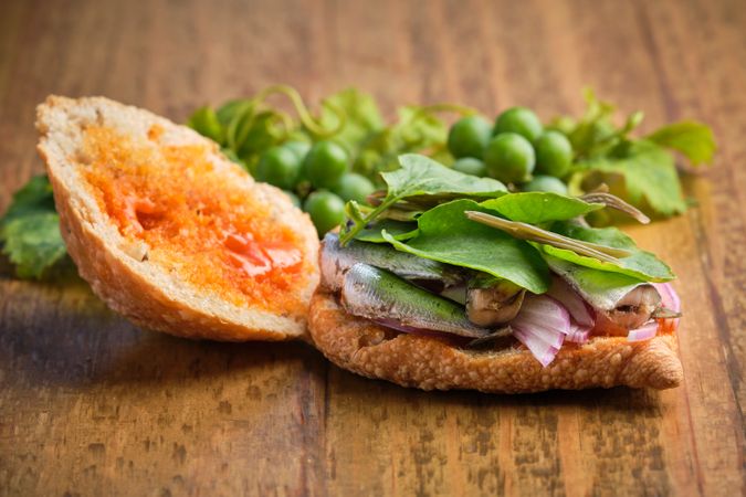 Half opened traditional harvest sandwich with sardines, meat and