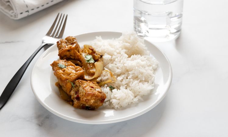Thai tofu curry with rice on a plate.
