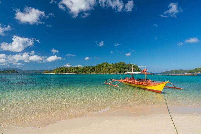 Yellow boat at rest on tropical beach