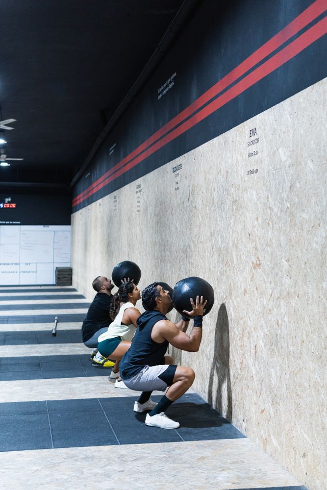 Hispanic sportspeople training with medical balls