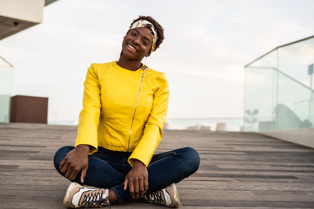 Smart woman sitting on wooden footpath
