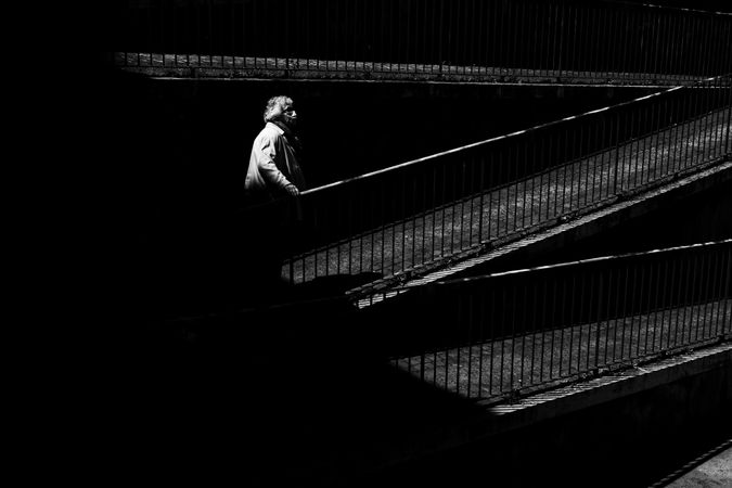 Woman in facemark ascending outdoor ramp