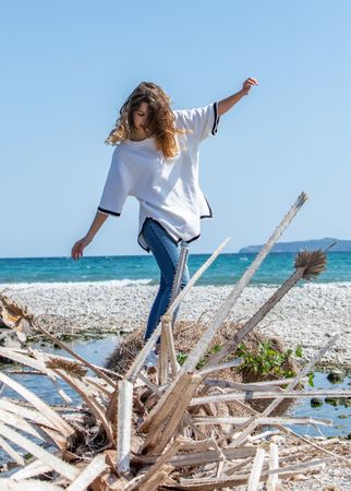 Young woman walking near dried plants