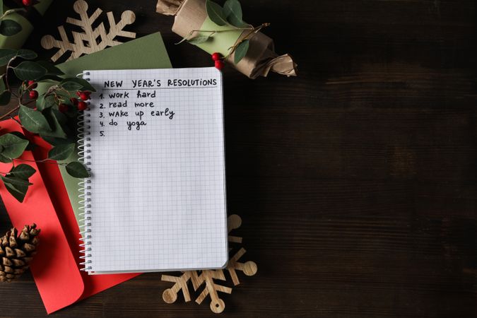 Envelopes, notepad with list and decorations on wooden background, space for text