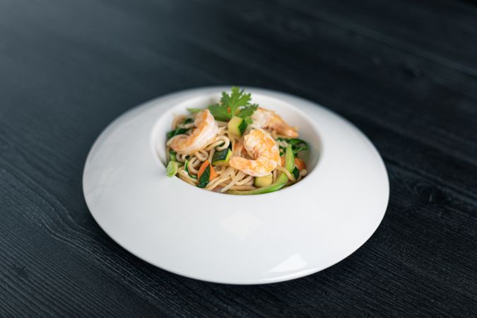 Tasty Pad Thai of vegetables and prawns in plate