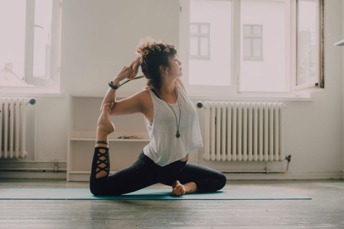 Fit woman practicing yoga at home