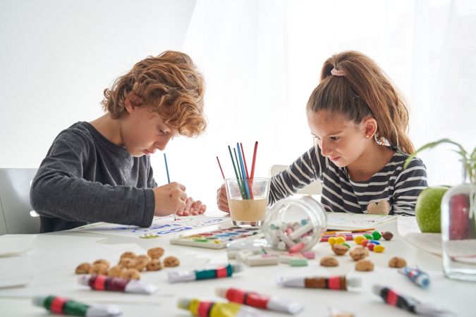 Focused children painting at table