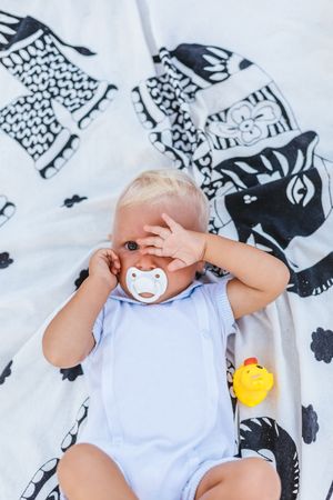 Blonde baby with sleepy expression