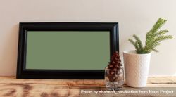Rectangular long picture frame with green interior mockup with branch and pinecone 0Plxe0