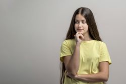 Thinking deeply, pensive woman in thoughtful pose for strategic planning and decision making; copy space.