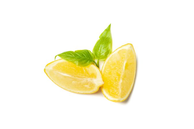 Lemon pieces isolated on light background. Ripe fruit