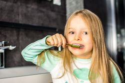 Girl brushing her teeth