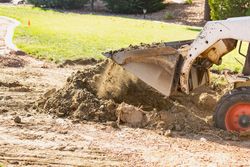 Small Bulldozer Digging In Yard For Pool Installation