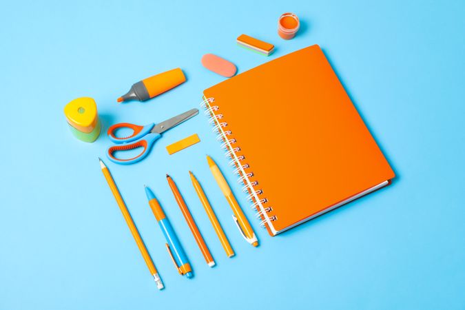 Flat lay composition with school supplies on color background, space for text