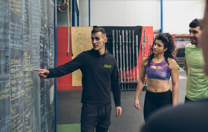 Coach explaining to athletes in the gym