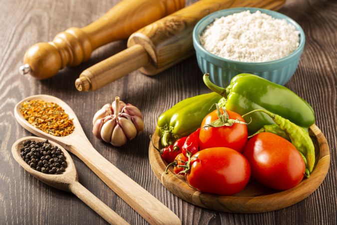 Wooden table with ingredients for pizza.