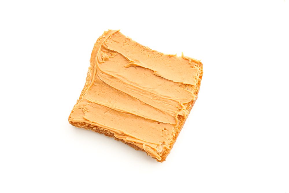 Peanut butter sandwich isolated on light background, top view. A traditional product of American cuisine