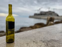 Empty wine bottle next to construction site