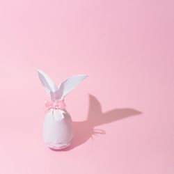Egg wrapped in light paper in Easter bunny shape