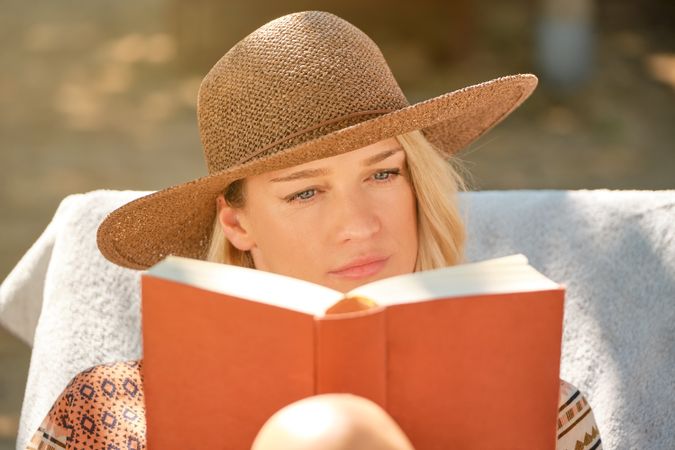 Young woman reading book seriously