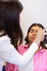 Beautician making eyebrow design and shading procedures