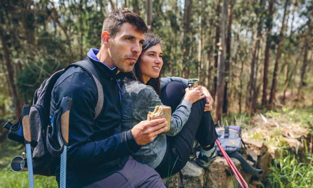 Couple pausing while doing trekking