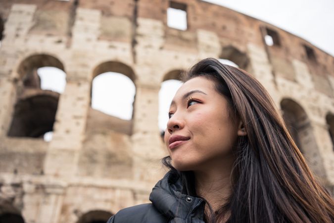 Cheerful Asian traveler outside famous landmark