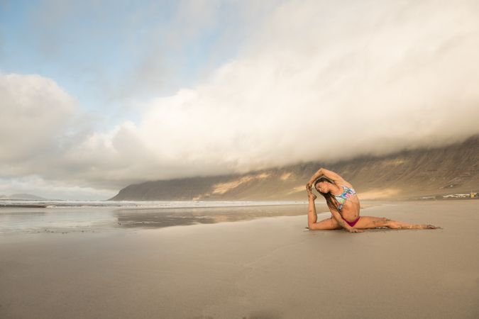 Woman stretching near sea